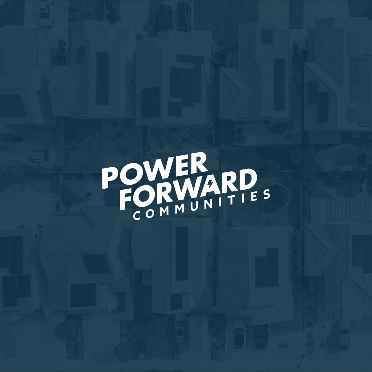 Square image with transparent dark teal background with monotone photo of aerial view of houses. A white Power Forward Communities logo in middle