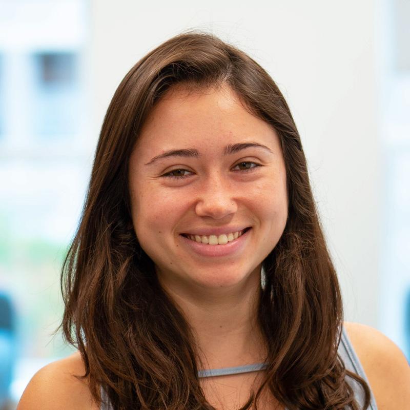 Headshot of Rachel Partridge, who is smiling and has long light brown hair. She wears a light blue sleeveless shirt.