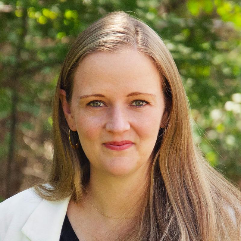 Headshot of Courtney St. John, who is slightly smiling and has long blonde hair.