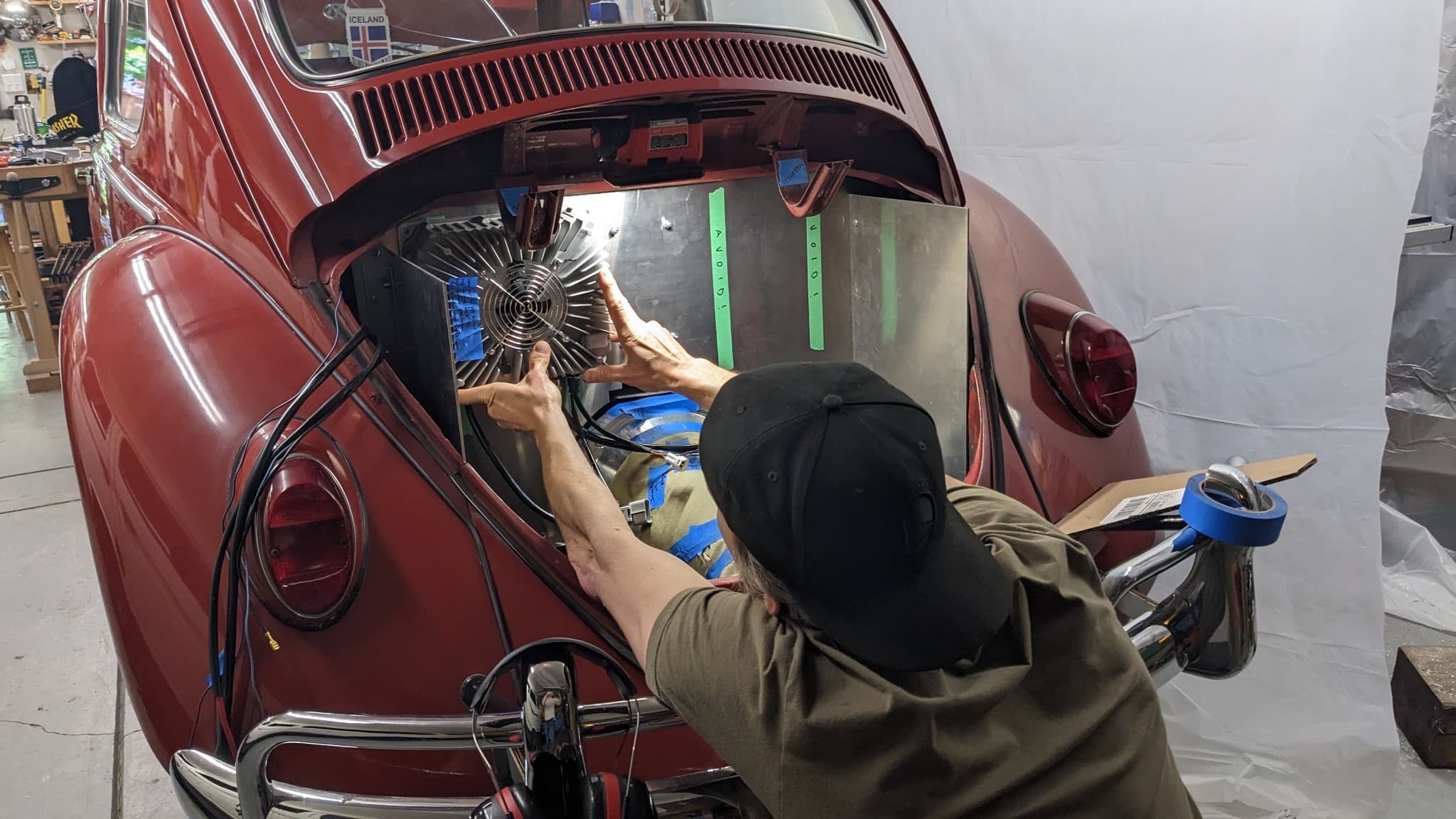 Thor Denmark working on his vintage VW Bug in his home workshop.